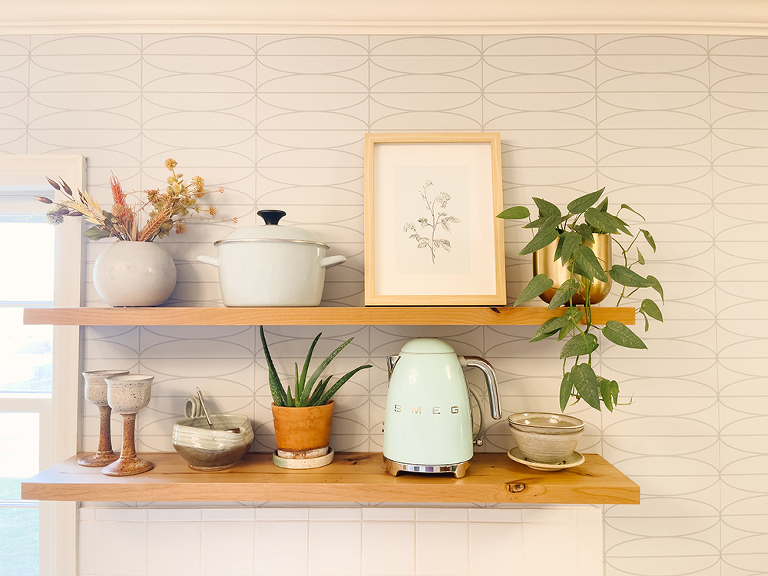 A mid-century kitchen with vintage-style peel-and-stick patterned wallpaper
